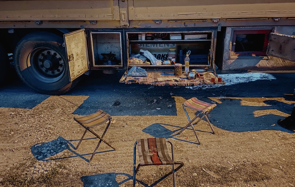 I preparativi per la cena a bordo strada fra riserve di cibo, fornelli e seggiole da campo
