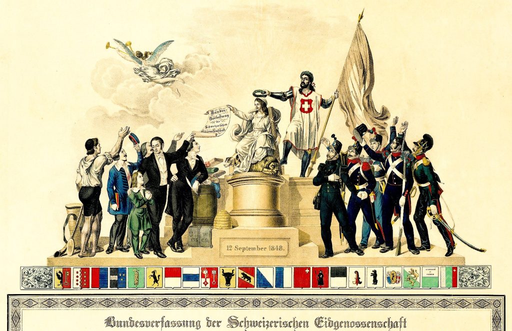 Immagine allegorica della Costituzione federale della Confederazione Svizzera del 12 settembre 1848. L’accostamento degli attori e la composizione della scena sottolinea il significato del momento fondativo del nuovo Stato federale (Wikipedia)